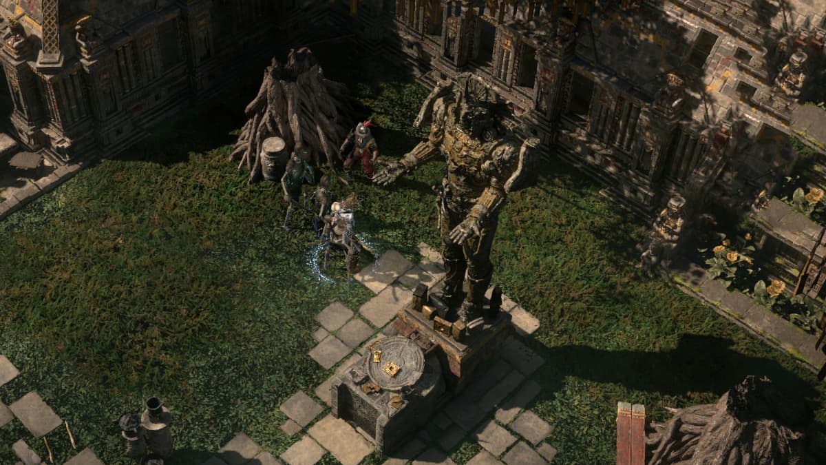 An ancient Aztec-inspired statue erected in a garden surrounded by a Witch and her minions, alongside a paved path, trees, and benches in Path of Exile 2.