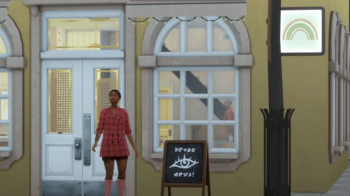 A Sim wearing a plaid pink dress standing outside a yellow building that's a small business in The Sims 4.