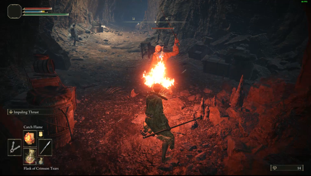 The Prophet class holding a torch in a cave in Elden Ring