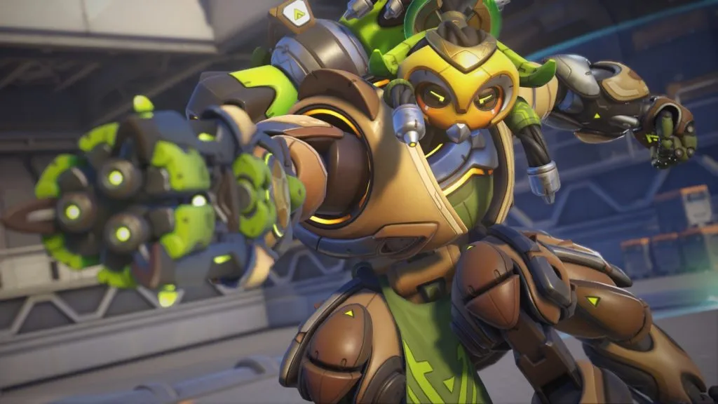 Orisa, a yellow and green robot, aims her arm cannon and prepares to fire in Overwatch 2.