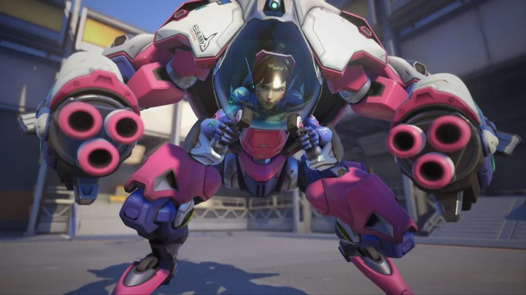 D.Va stands in her pink mech suit, aiming her guns at a target in Overwatch 2.